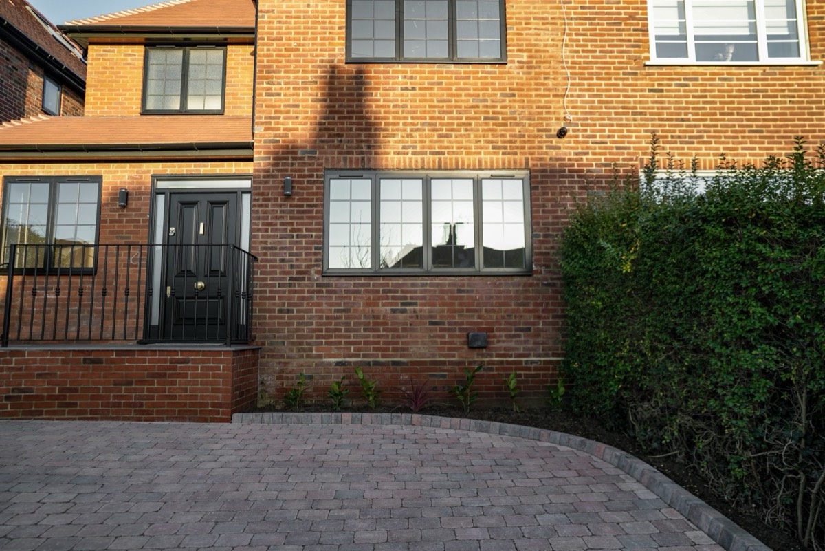 Front of a brick house with new windows and front door